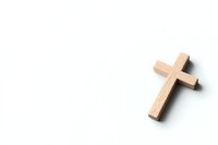 Minimalist wooden cross on white background with shadow casting dramatic lighting effect, isolated religious symbol for faith-based designs and publications.
