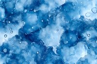 Abstract watercolor background in deep blue tones with water drops and organic shapes creates dreamy underwater atmosphere for creative design projects.