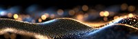 Abstract golden particle wave with bokeh lights on black background, creating luxurious digital landscape for technology or celebration designs.