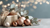 Elegant gift box with rose gold ribbon surrounded by copper and white Christmas ornaments and eucalyptus leaves on festive bokeh background.