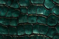 Macro shot of emerald green reptilian skin texture with dark cracked pattern and scales creating an organic geometric surface design for luxury fashion backgrounds.