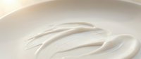 Smooth white cream texture with elegant swirls, skincare cosmetic product background for beauty and wellness applications in soft neutral tones.