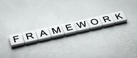 White letter tiles spelling FRAMEWORK on gray textured surface for business strategy and organizational structure concepts.