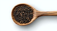 Black peppercorns in wooden spoon on white background, overhead view. Natural organic whole spice ingredient for cooking and seasoning isolated.