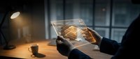 Businessman using futuristic transparent tablet with glowing digital interface and holographic data visualization in modern office environment at night.