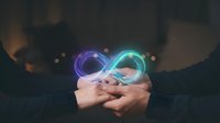 Businessman hands holding glowing infinity symbol with colorful neon lights representing endless possibilities, eternal growth and unlimited potential in business.