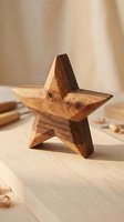 Handcrafted wooden star decoration on natural wood surface with warm lighting for rustic home decor and artisan crafts projects.