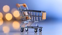 Empty shopping cart on blue background with golden bokeh lights, retail commerce concept for online stores and e-commerce business marketing.