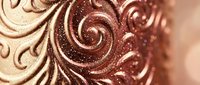Elegant chocolate swirls with golden shimmer creating luxurious decorative pattern for confectionery and dessert design applications.
