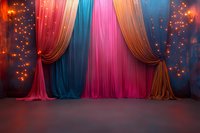 Magical stage backdrop with colorful draped curtains in pink, blue, and brown tones illuminated by warm glowing lights creating dreamy theatrical atmosphere.