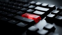 Red cyber security button on black computer keyboard highlighting digital protection and online safety concepts for business technology applications.