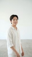 Young Asian male in casual white linen shirt, smiling at camera against neutral background. Suitable for business, lifestyle, and portrait projects.