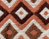 Geometric brown and terracotta pattern with diamond shapes and zigzag lines creates seamless repeat design for fabric, wallpaper and home decor backgrounds.
