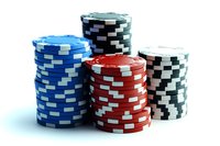 Colorful casino poker chips stacked in towers on white background for gambling and gaming concepts.