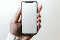 Female hands holding modern smartphone with blank white screen against light background. Mockup for app or website presentation.