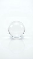 Clear glass sphere crystal ball on white background with reflection for fortune telling meditation and spiritual practices.