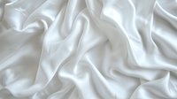 Luxurious white silk fabric with soft waves and elegant folds creating gentle shadows and highlights, suitable for wedding, fashion, and luxury design backgrounds.