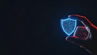 Digital cybersecurity shield protection concept with glowing blue holographic icon held in human hands against dark background for tech presentations.