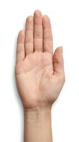Open palm hand gesture showing stop sign isolated on white background for communication and body language concepts.
