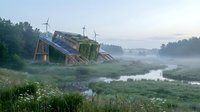 Abandoned wooden house ruins in misty rural landscape at dawn with overgrown vegetation and calm water reflection creating atmospheric countryside scenery.