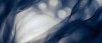 Abstract blue flowing fabric with soft bokeh lights creating dreamy ethereal atmosphere for luxury branding and elegant design projects.
