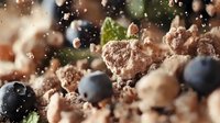 Fresh blueberries scattered among crumbled chocolate cookie pieces and cake crumbs create appetizing dessert texture with bokeh light effect in macro shot.