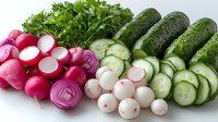 Fresh organic vegetables arranged in rows including sliced radishes, parsley, cucumbers on white background, ready for salad preparation or healthy eating concept.