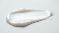 White cream or lotion smear isolated on light background, suitable for cosmetic, skincare, and beauty product packaging design mockups.