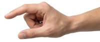 Young adult male hand with light skin tone gesturing small size or measuring, isolated on white background for design, presentations, and educational materials.