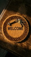 Round coir welcome mat with vintage keys on rustic wooden surface, symbolizing home ownership, real estate, and new beginnings.