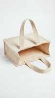 Beige canvas tote bag with woven handles, open top design, isolated on white background. Suitable for branding, product mockups, retail packaging, and e-commerce use.