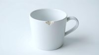 White ceramic mug with small chip damage on rim, isolated on light background. Suitable for product photography, kitchenware catalogs, damage documentation.