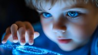 Young child with bright blue eyes illuminated by glowing digital screen light in dark room, touching interactive display surface, representing digital native generation.