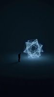 Silhouetted male professional observing glowing geometric wireframe network structure in dark space, representing innovation, technology, data analysis, and digital transformation concepts.
