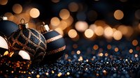 Navy blue and copper striped Christmas ornaments on dark glittery surface with golden bokeh lights creating magical holiday atmosphere.