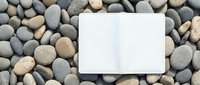 White blank card mockup on natural river stones background for branding design projects and presentations.