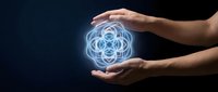 Hands holding glowing sacred geometry symbol with blue light energy on dark background for spirituality and wellness concepts.