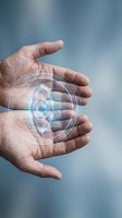 Hand holding glowing eye hologram symbol against blue sky background, representing digital vision, surveillance, security technology, and biometric authentication systems.