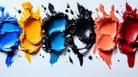Vibrant crushed makeup pigments in blue, yellow, black, coral and red arranged in artistic smears on white background, showcasing cosmetic texture and color palette.