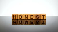 Wooden letter blocks spelling HONEST with mirror reflection on glossy surface against white background for business ethics and integrity concepts.