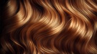 Luxurious wavy brown and golden hair texture with natural highlights and shine, creating flowing curves and patterns. Close up macro shot on black background.
