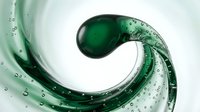 Green liquid water wave with bubbles swirling in dynamic motion on white background. Fresh clean splash for beverage advertising and design projects.