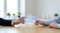 Business professionals hands reaching toward glowing medical cross hologram on office desk representing healthcare technology partnership and collaboration.