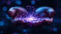 Magical glowing sparkles and light particles floating above cupped hands against dark background with bokeh effect, creating mystical atmosphere.