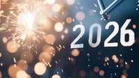 Festive New Year 2026 celebration with clock and sparkler against dark blue background with golden bokeh lights.