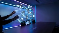 Hands interacting with holographic globe display showing global network connections and digital data visualization in modern tech environment.