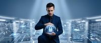 Professional businessman in dark suit holding glowing digital security shield with lock icon in futuristic cyber technology environment for data protection concepts.