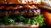 Juicy beef burger with fresh lettuce and sesame seed bun, appetizing fast food meal for restaurant menus, food photography, and culinary advertising.