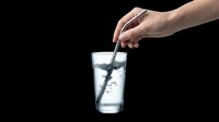 Hand stirring water in a clear glass with a metal straw, isolated on transparent background. Ready for stickers, print on demand, T-shirt design, and clipart use.