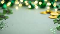 St Patricks Day background with shamrock leaves, gold coins and bokeh lights creating festive Irish holiday atmosphere for celebration design.